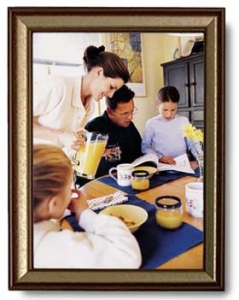 A framed image of a mom pouring orange juice while her family reads a SKITuations script.